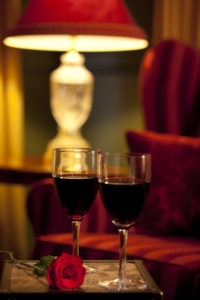 Relax with a glass of red wine by the fire